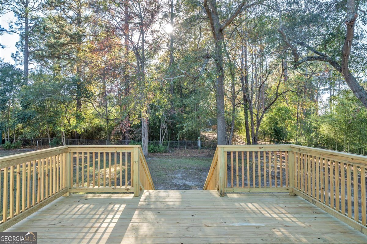 1806 Knox Street Dublin, GA 31021 - Photo 32 of 49 a view of backyard with deck and trees
