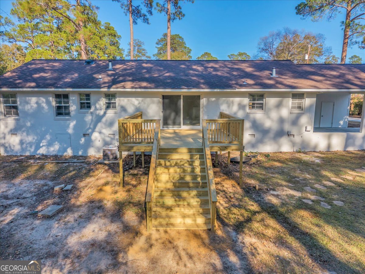 1806 Knox Street Dublin, GA 31021 - Photo 39 of 49 a view of a patio with table and chairs with wooden floor
