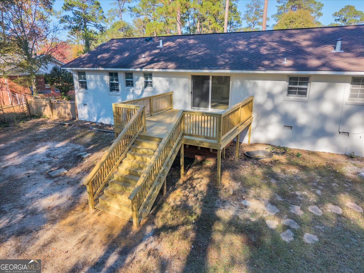 1806 Knox Street Dublin, GA 31021 - Photo 45 of 49 a view of a patio with table and chairs with wooden fence