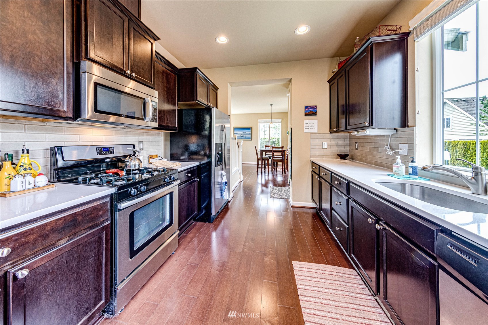 21821 38th Drive Southeast Bothell, WA 98021 - Photo 13 of 29 a kitchen with stainless steel appliances granite countertop wooden cabinets a sink dishwasher a stove and a refrigerator