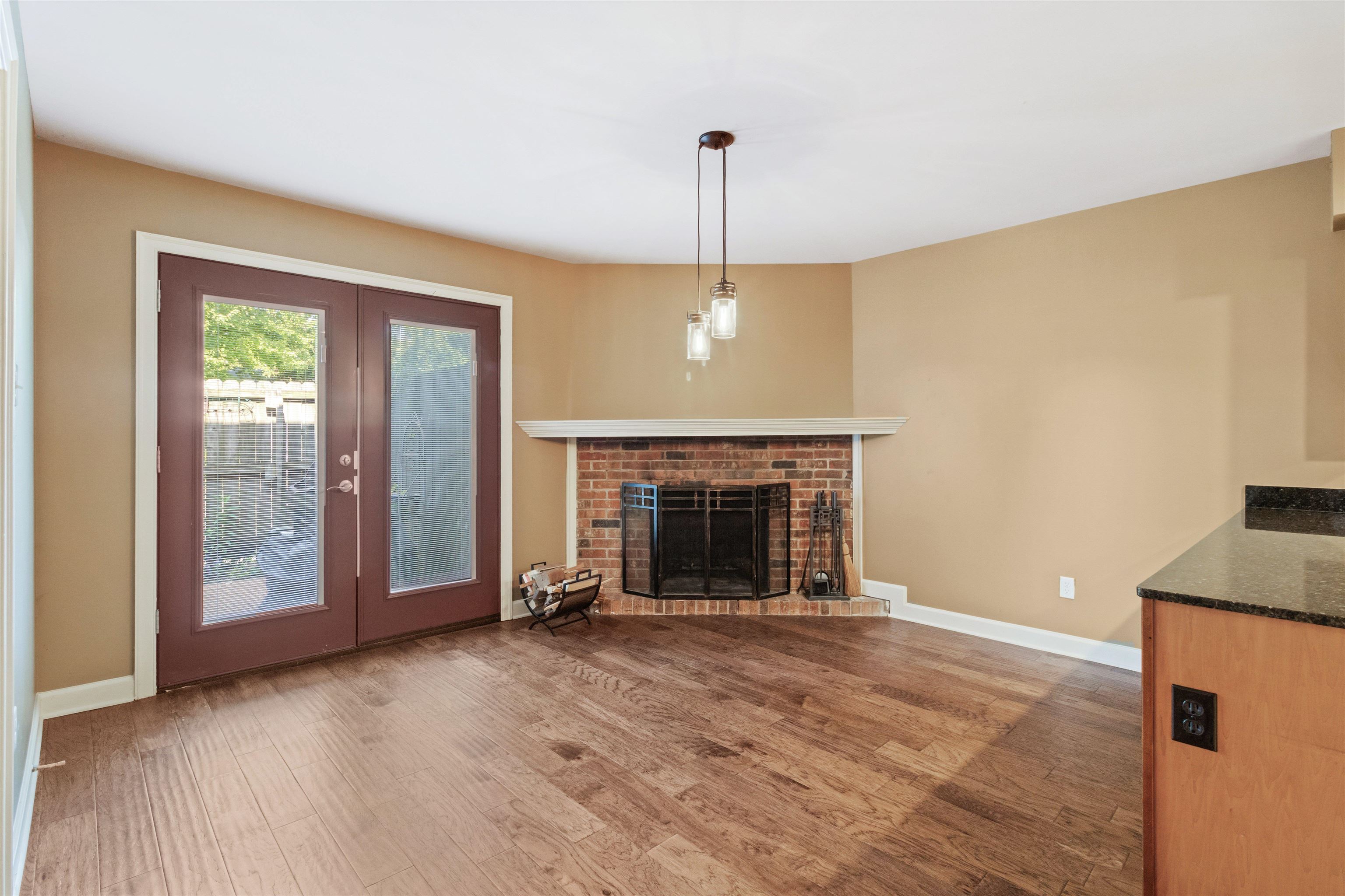700 St Augustine Square, Unit D Memphis, TN 38104 - Photo 12 of 31 a view of an empty room with a fireplace and a window