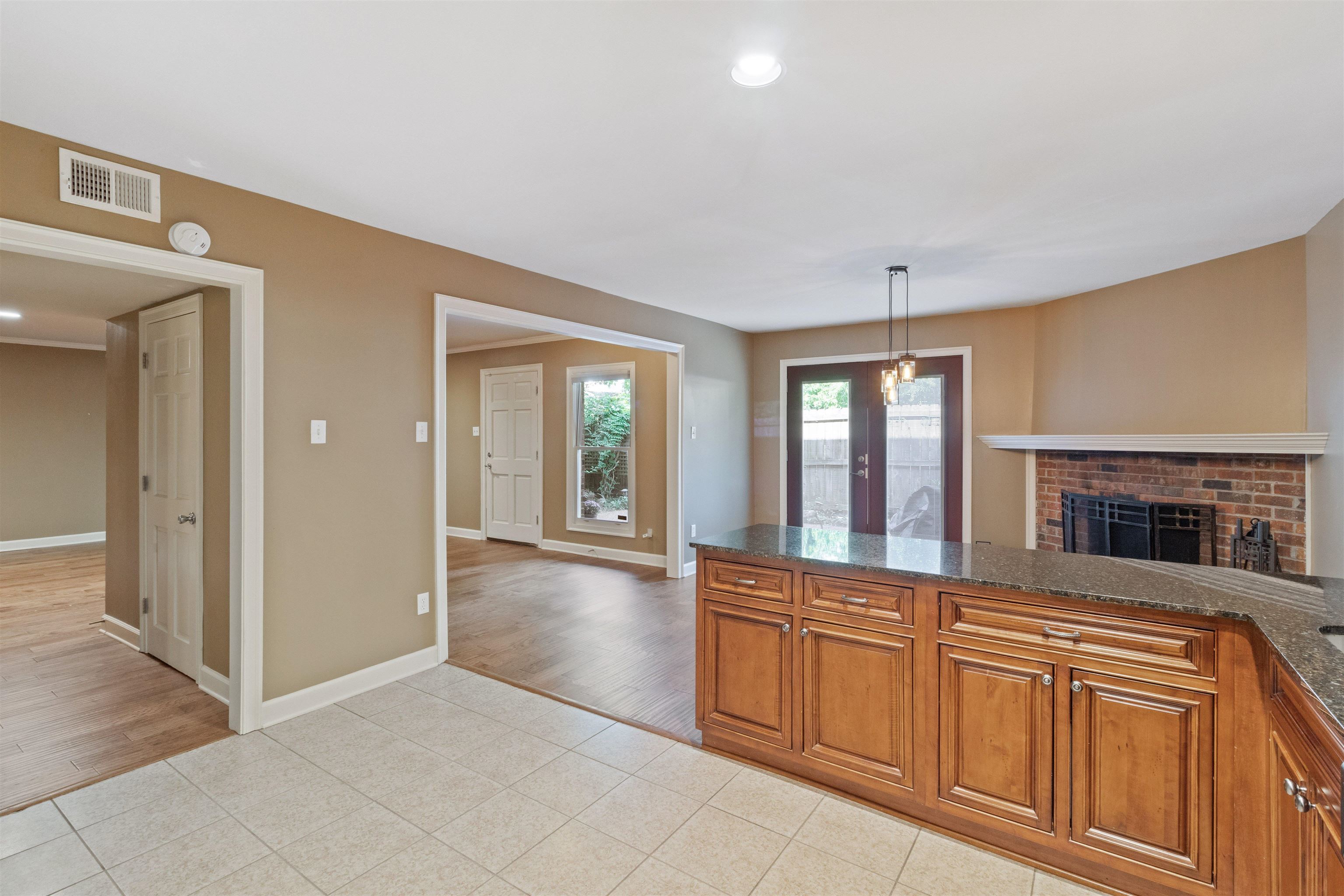 700 St Augustine Square, Unit D Memphis, TN 38104 - Photo 16 of 31 a view of a livingroom with wooden floor and kitchen view