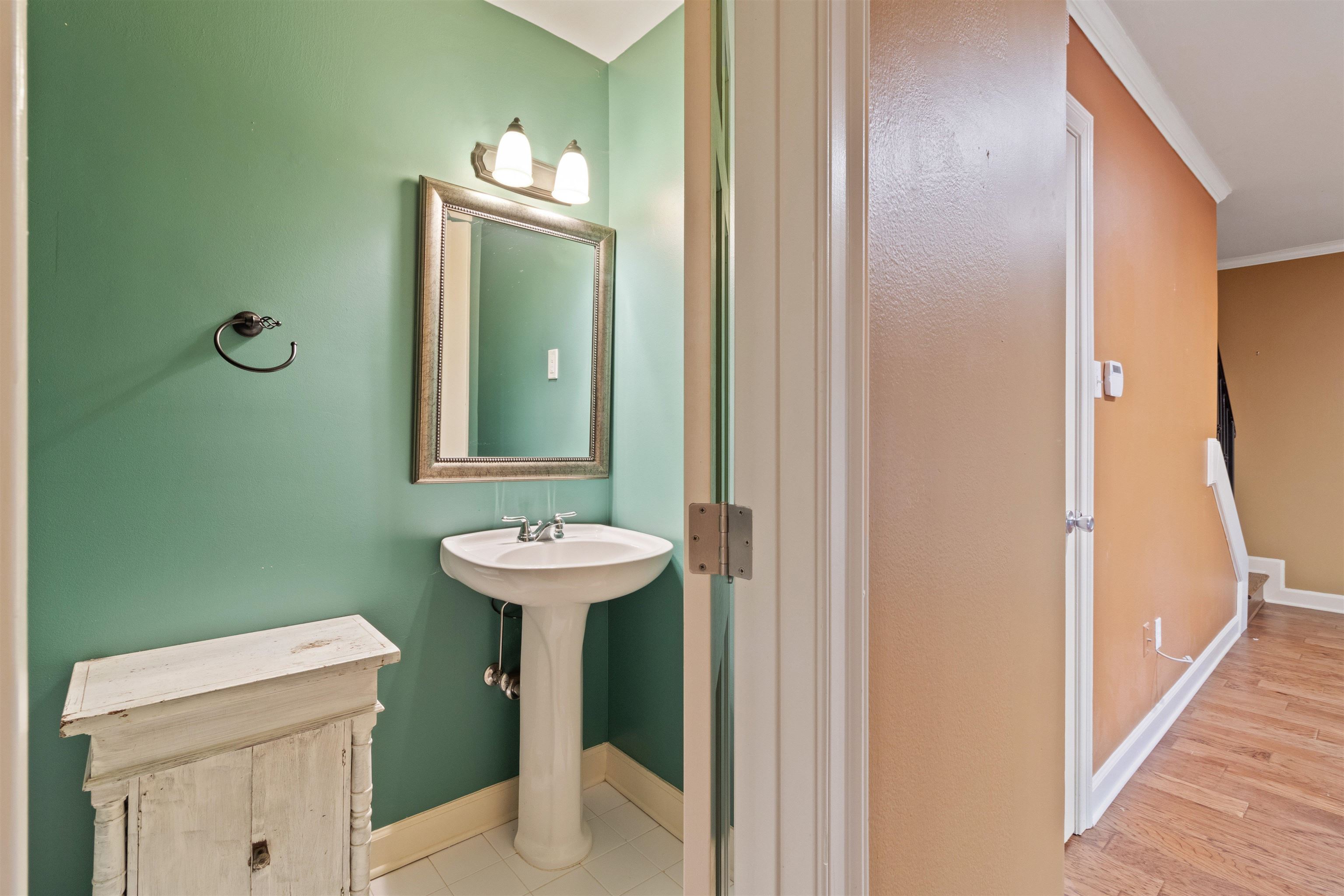 700 St Augustine Square, Unit D Memphis, TN 38104 - Photo 19 of 31 a bathroom with a sink a toilet and mirror