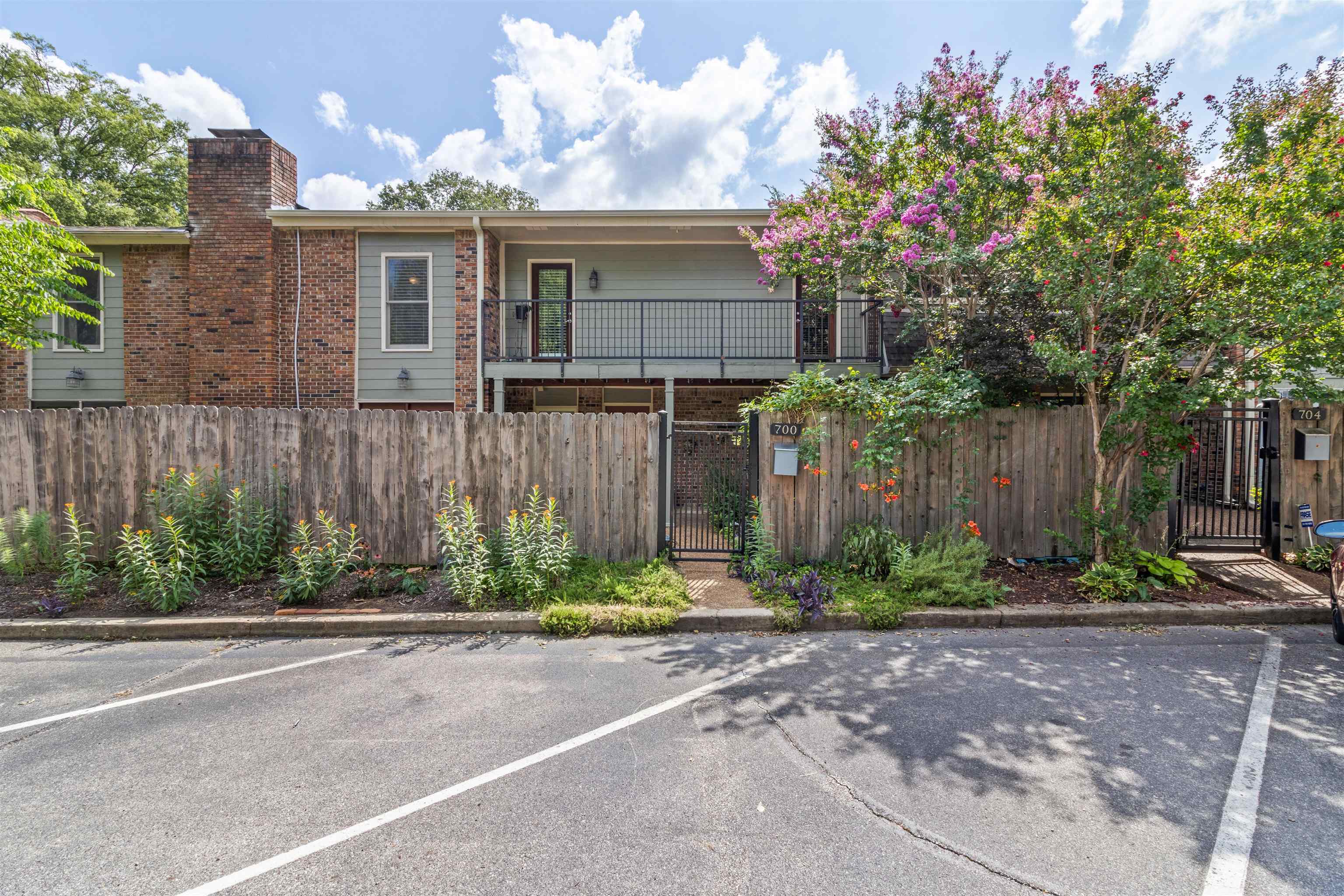700 St Augustine Square, Unit D Memphis, TN 38104 - Photo 2 of 31 a front view of a house with a yard and a garage