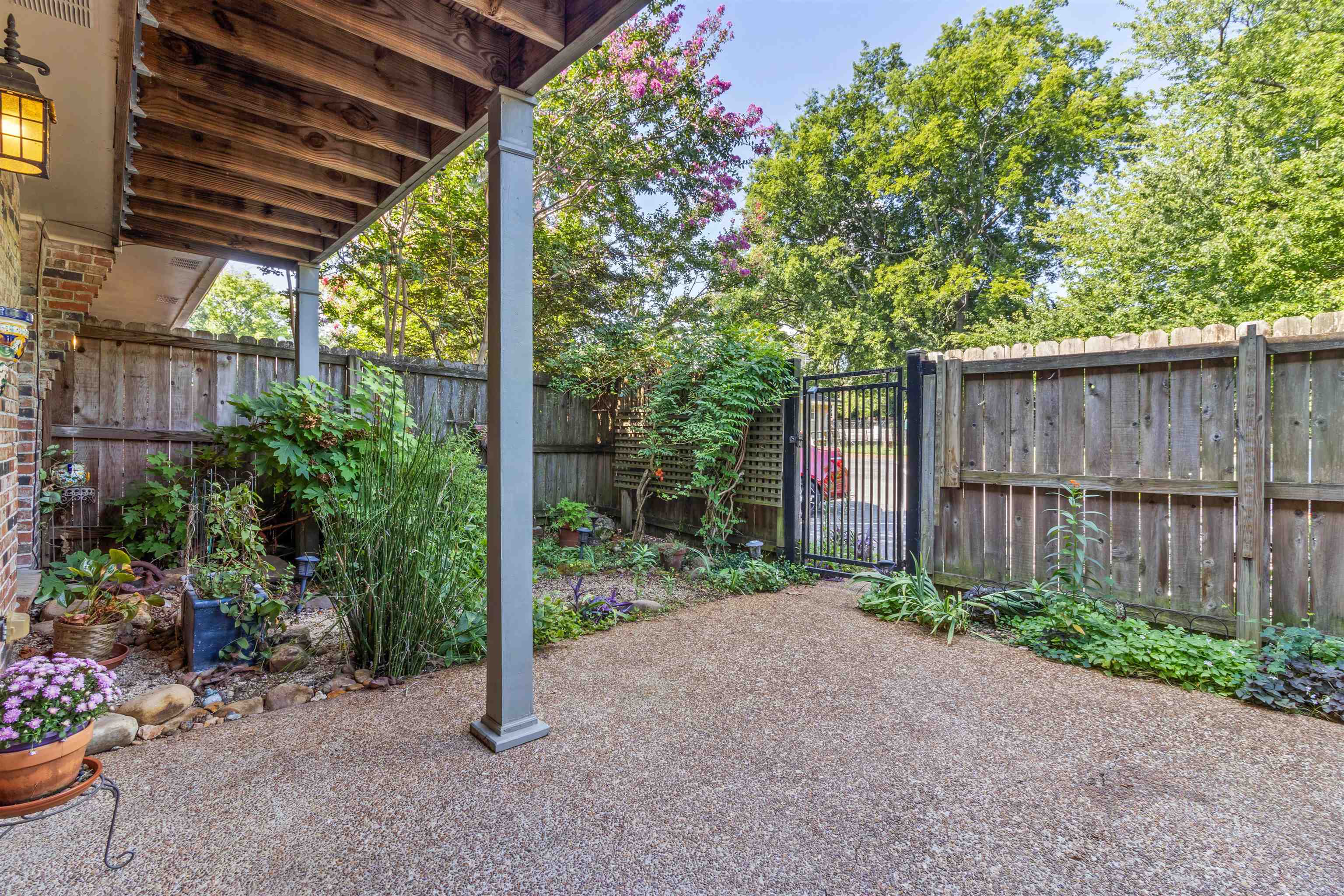 700 St Augustine Square, Unit D Memphis, TN 38104 - Photo 5 of 31 a view of a backyard with potted plants and wooden fence