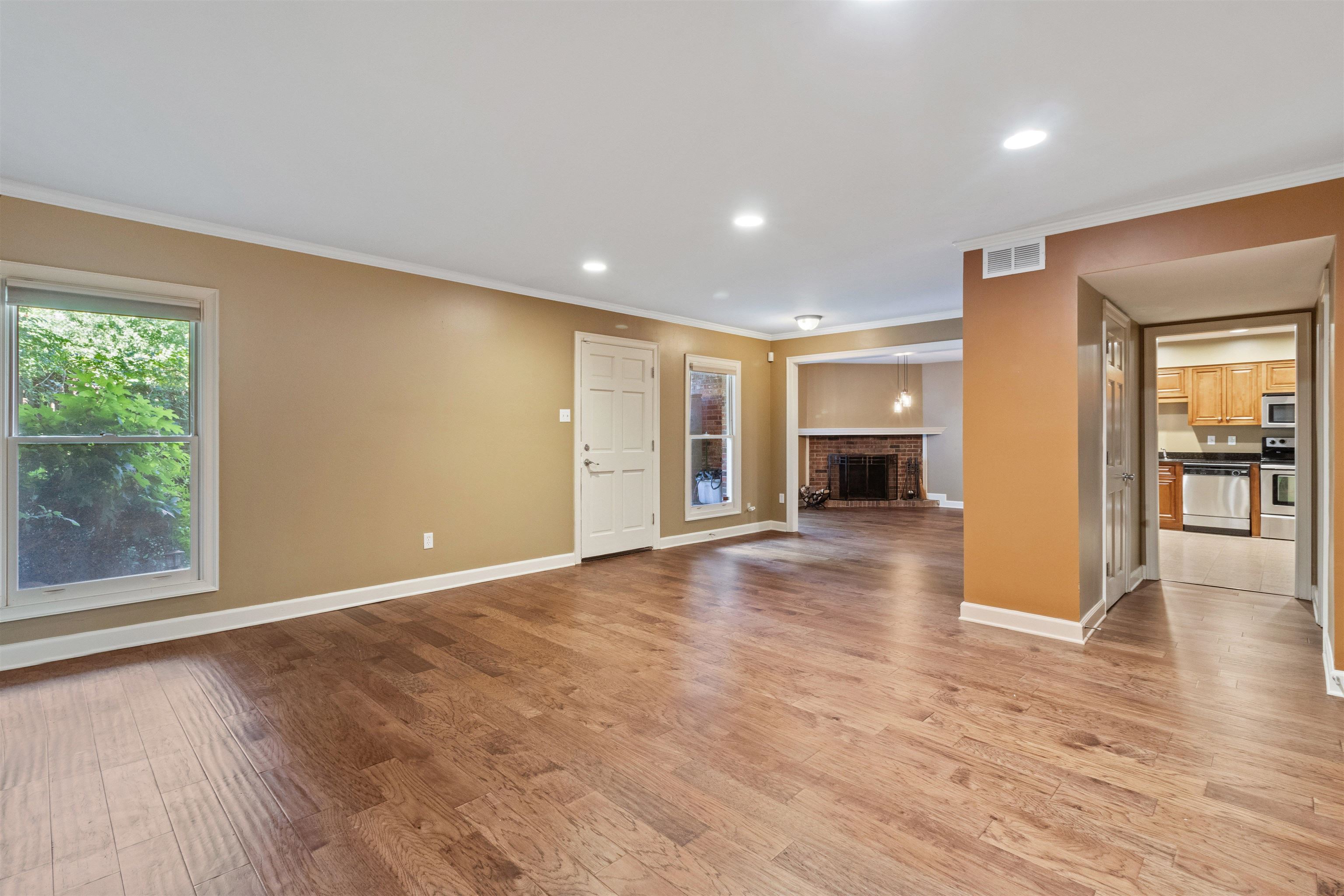 700 St Augustine Square, Unit D Memphis, TN 38104 - Photo 9 of 31 a view of a livingroom with wooden floor and a kitchen