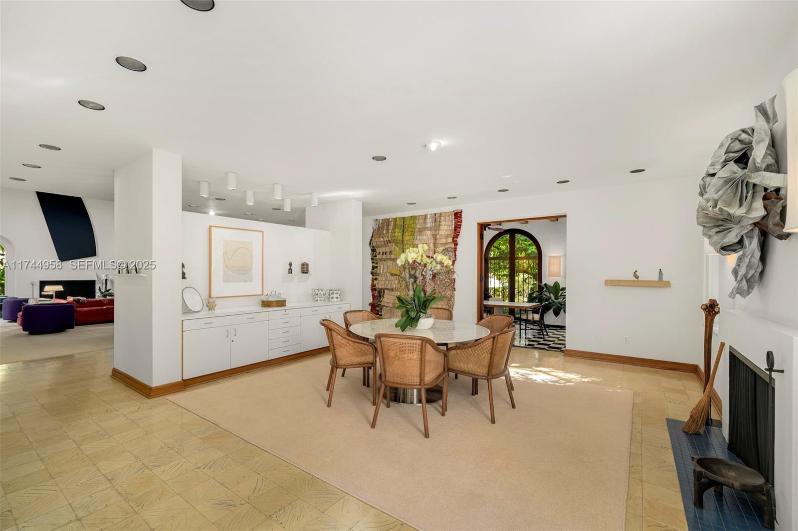 4197 Douglas Road Miami, FL 33133 - Photo 12 of 42 a living room with furniture a fireplace and a flat screen tv