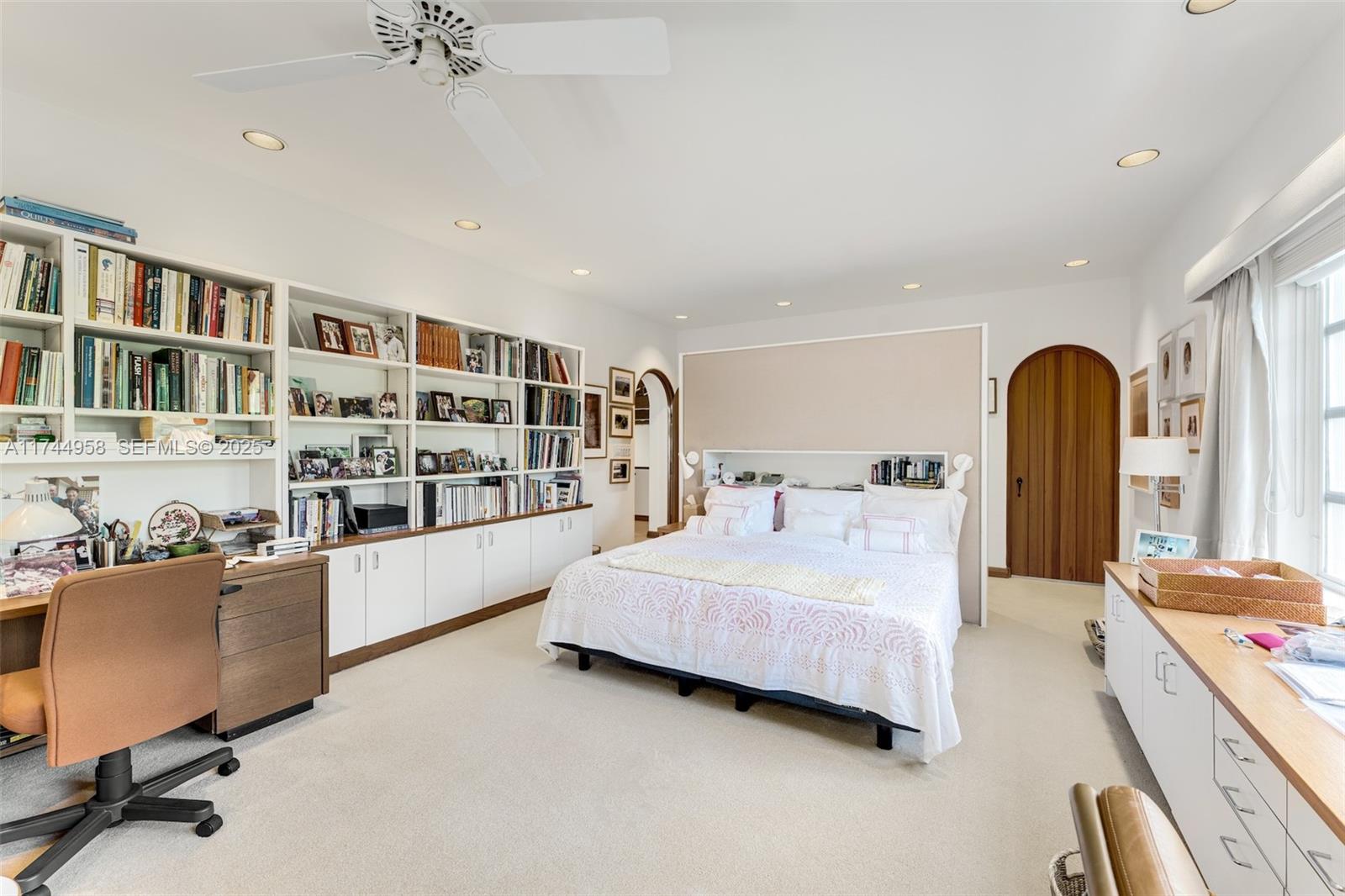 4197 Douglas Road Miami, FL 33133 - Photo 17 of 42 a room with a bed furniture and a book shelf