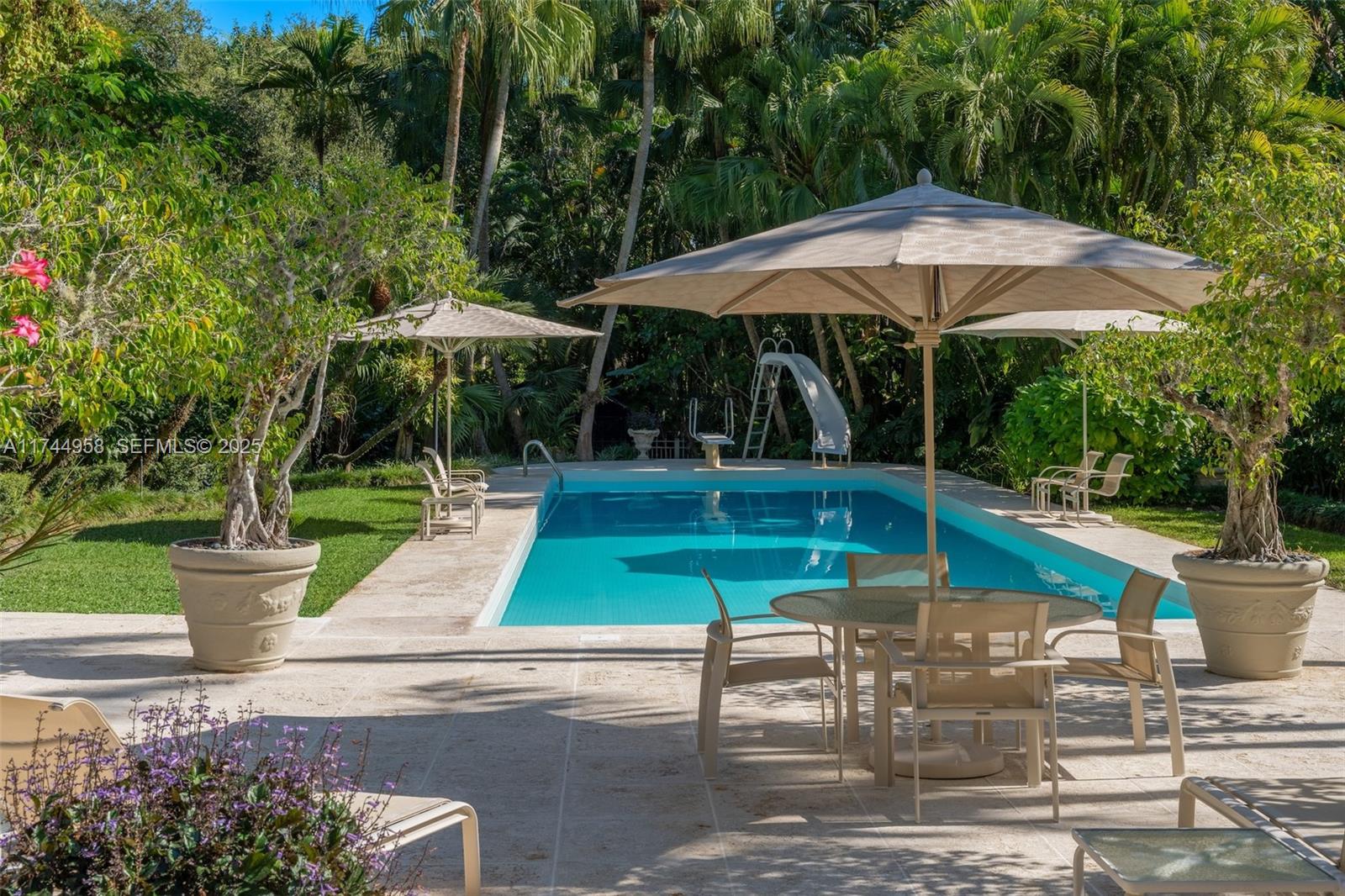 4197 Douglas Road Miami, FL 33133 - Photo 24 of 42 a view of backyard with swimming pool and table