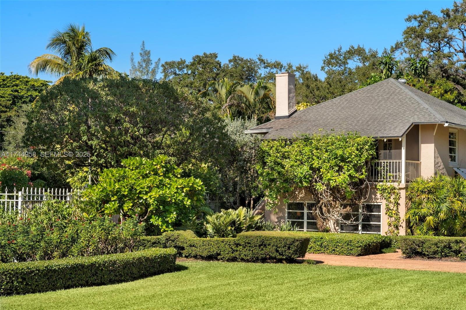 4197 Douglas Road Miami, FL 33133 - Photo 28 of 42 a front view of a house with a garden