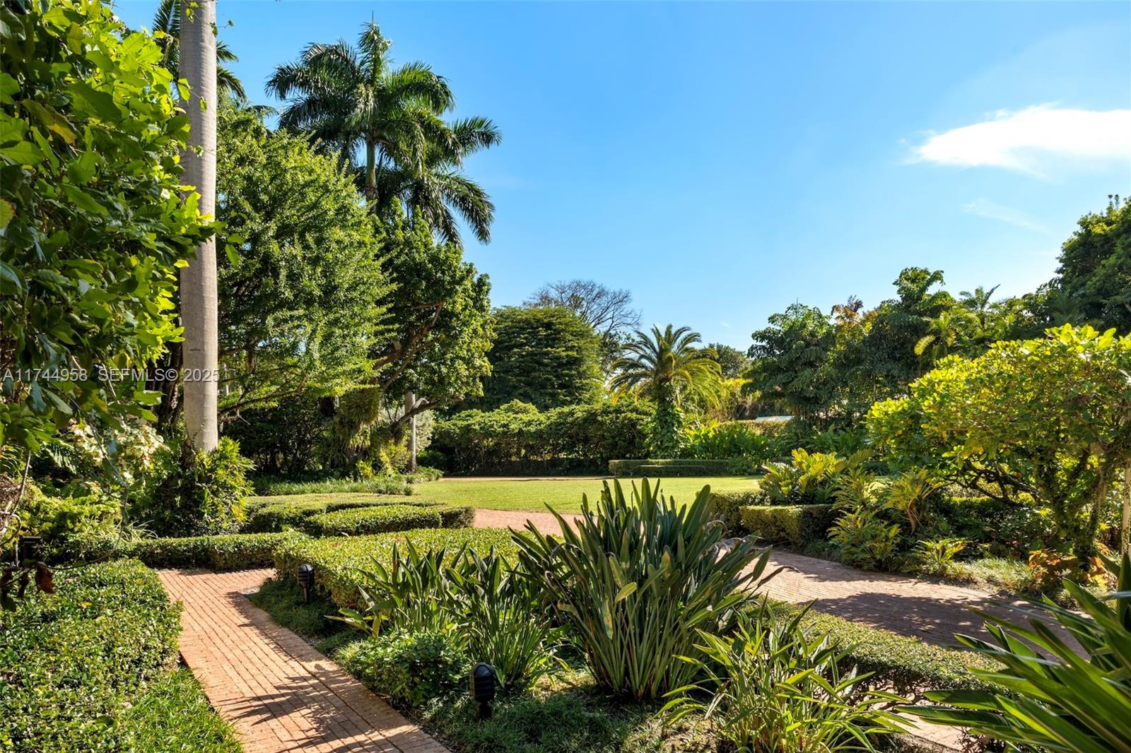 4197 Douglas Road Miami, FL 33133 - Photo 3 of 42 a view of a garden with a tree
