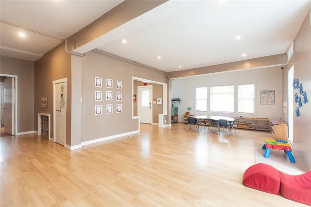 a view of a living room with furniture and wooden floor