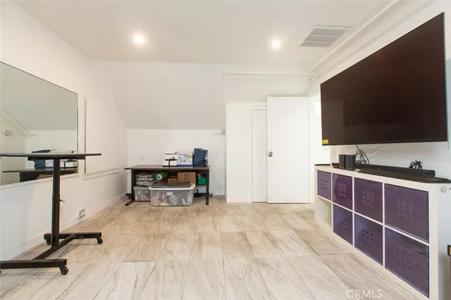 a bedroom with furniture and a wooden floor