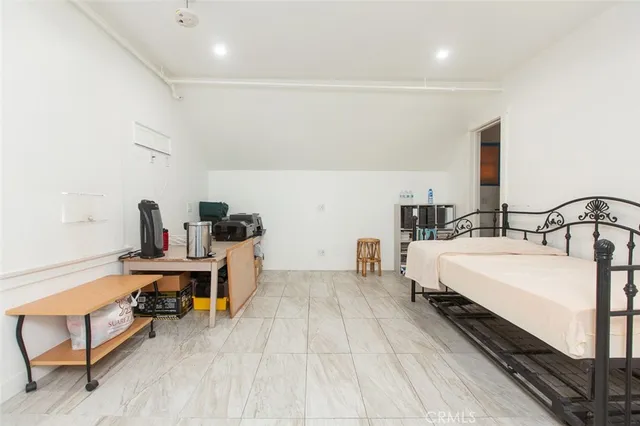 a spacious bedroom with a bed and a table