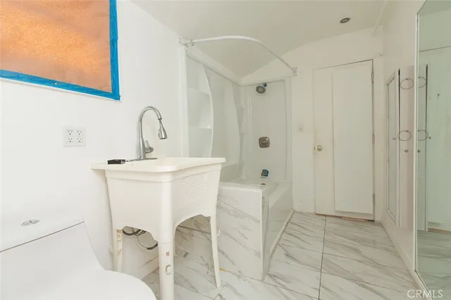 a view of kitchen with a refrigerator washer and a window