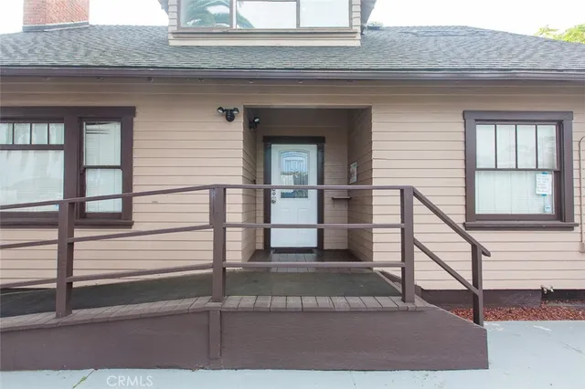 a view of a house with a balcony and stairs