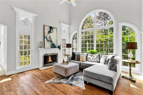 a bedroom with a bed and large windows