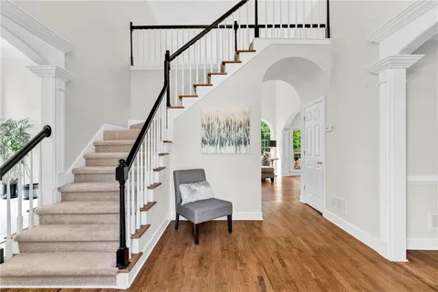 a bedroom with a bed and a table chair