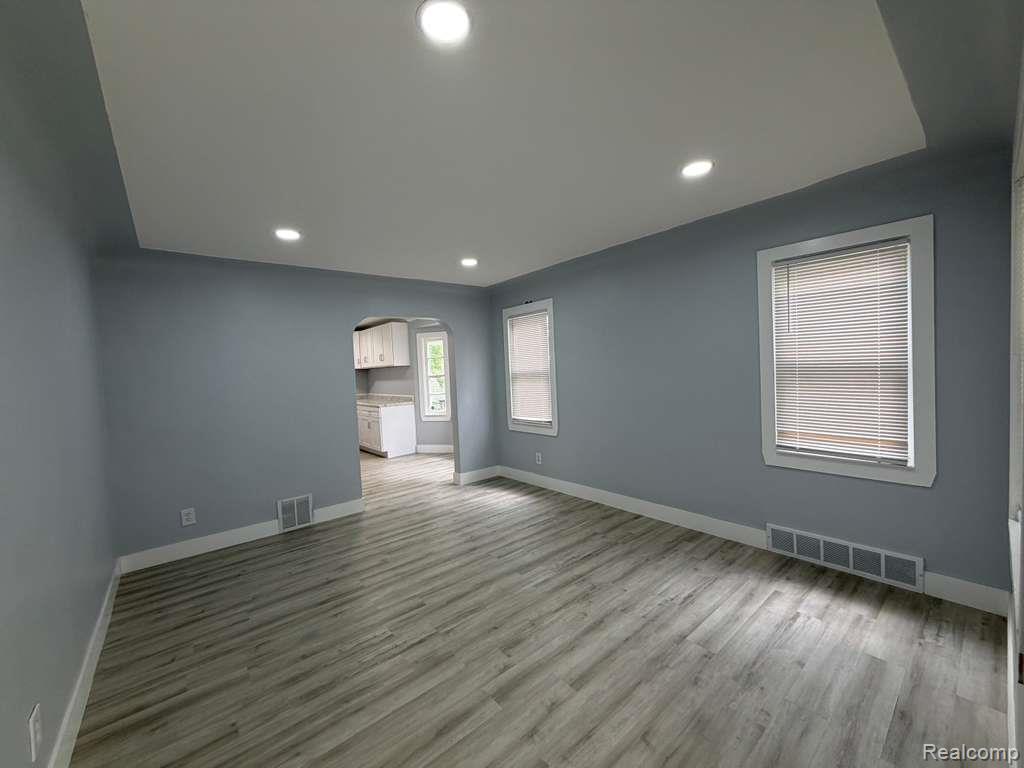 7416 Heyden Detroit, MI 48228 - Photo 4 of 16 Spare room with arched walkways, light wood-type flooring, and recessed lighting