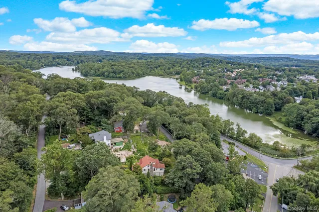 an aerial view of residential houses with outdoor space and street view