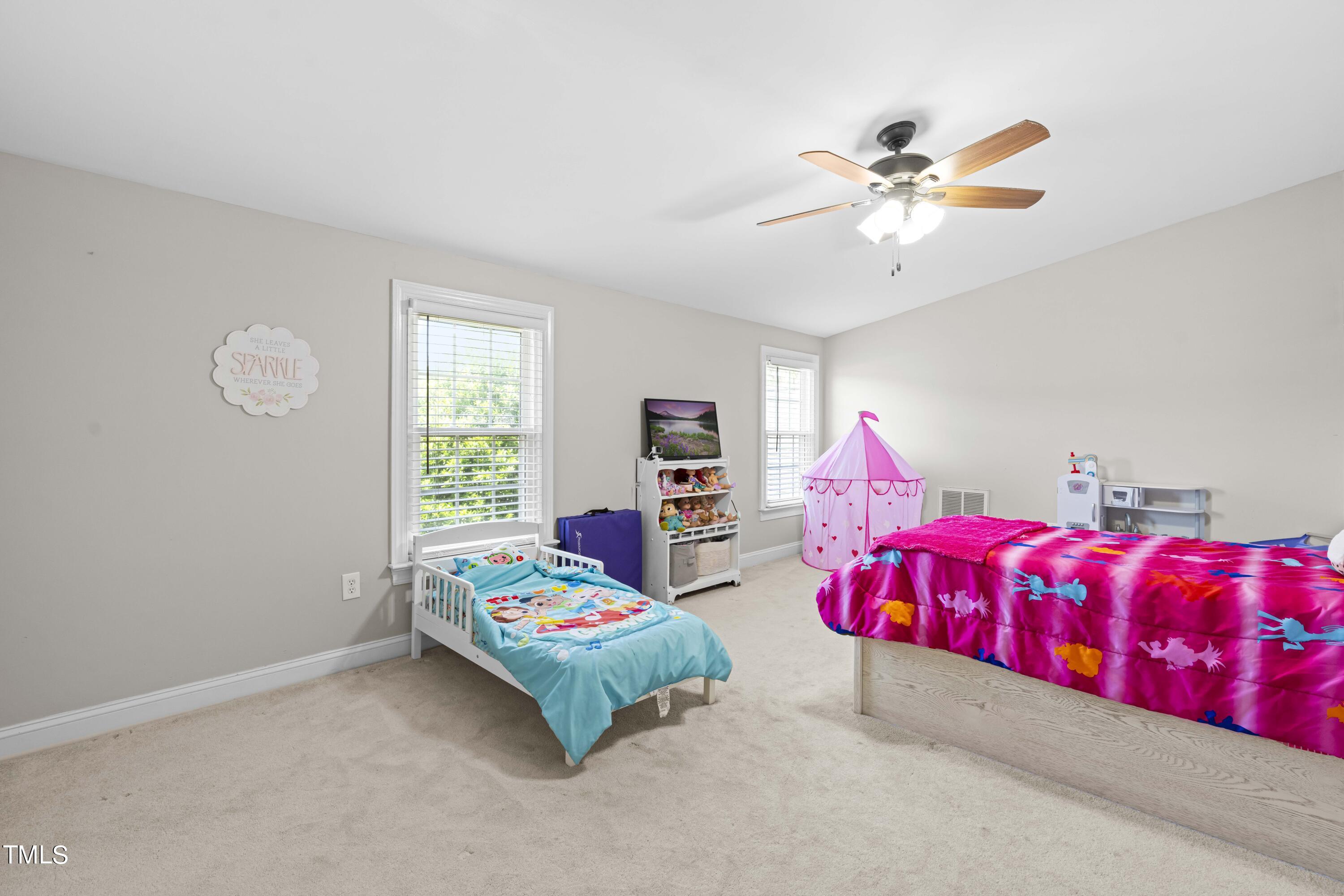 44 Oak Hill Drive Dunn, NC 28334 - Photo 14 of 40 a bedroom with a bed and a chandelier