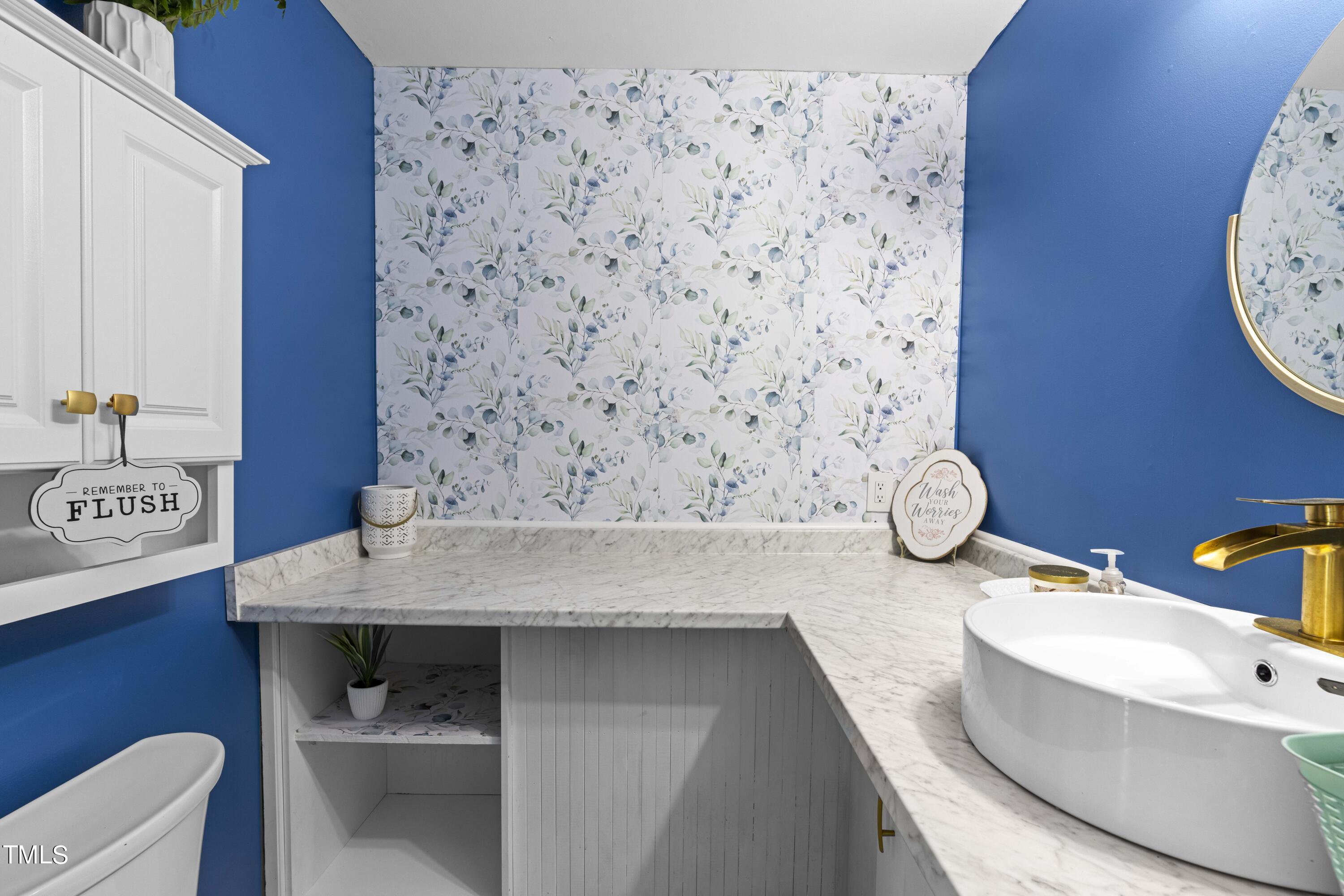 44 Oak Hill Drive Dunn, NC 28334 - Photo 30 of 40 a bathroom with a granite countertop sink and a mirror