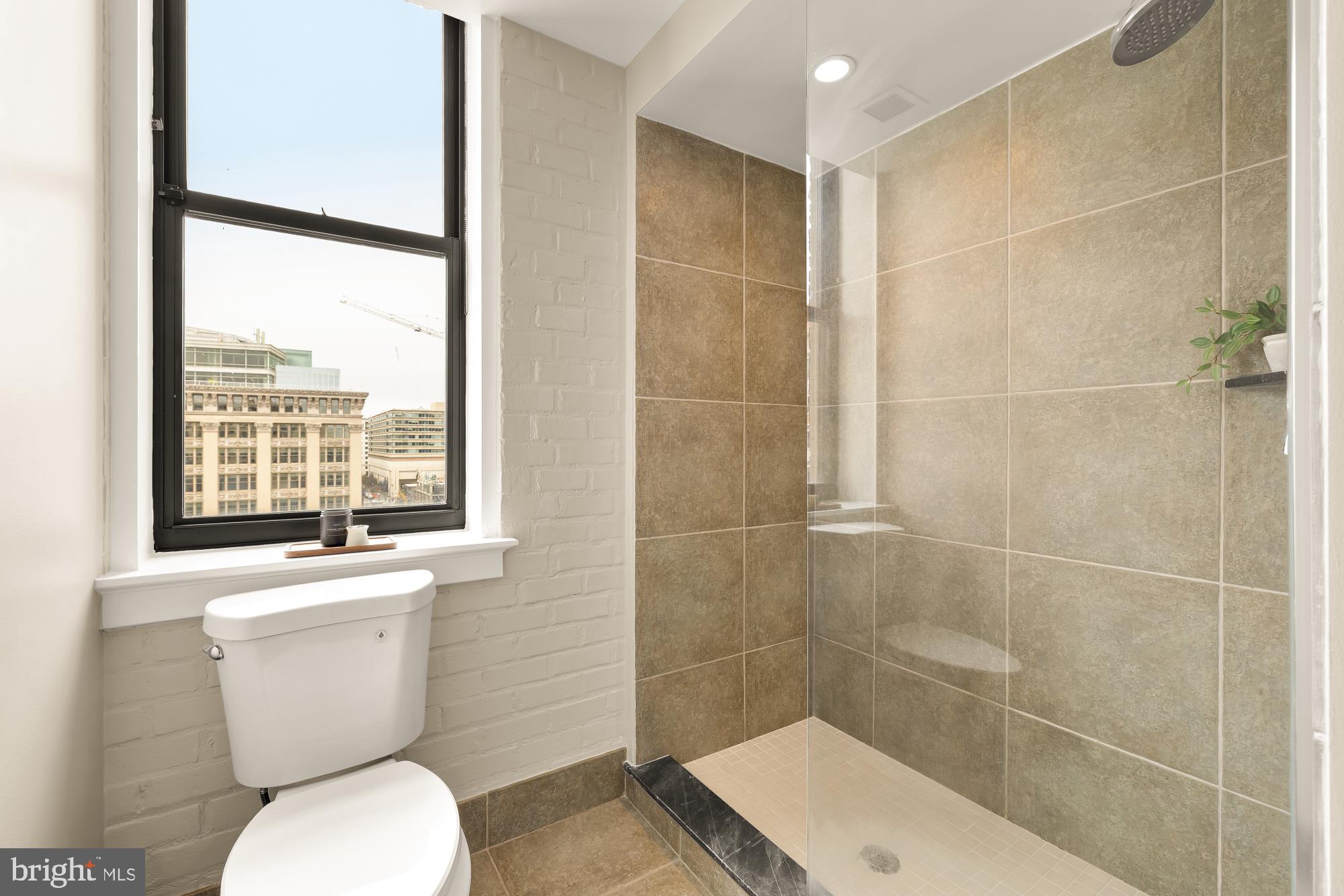 916 G St. Northwest, Unit 806 Washington, DC 20001 - Photo 17 of 19 a bathroom with a toilet and a shower