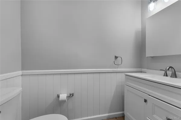 a bathroom with a sink a toilet and vanity