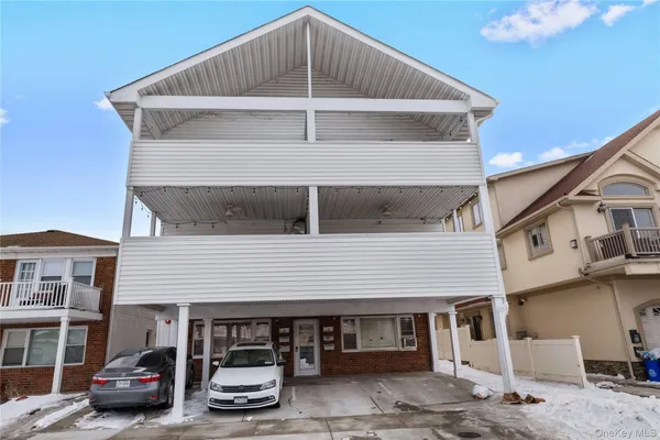 a view of a car park in front of house