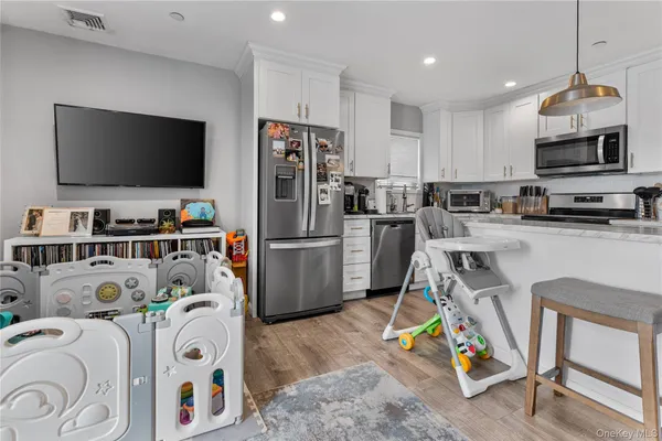 a kitchen that has a lot of appliances and cabinets