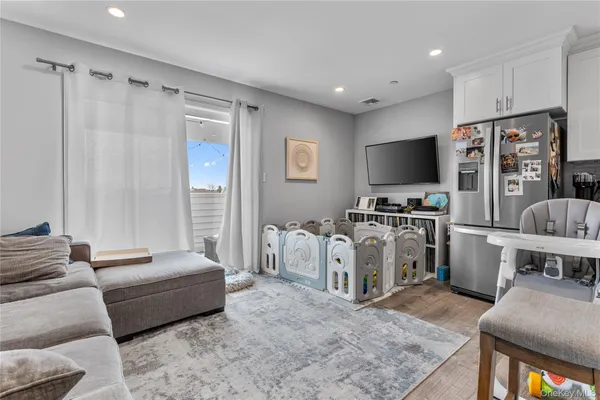 a bedroom with furniture and a flat screen tv