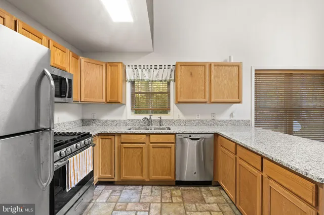 a kitchen with a stove sink and cabinets