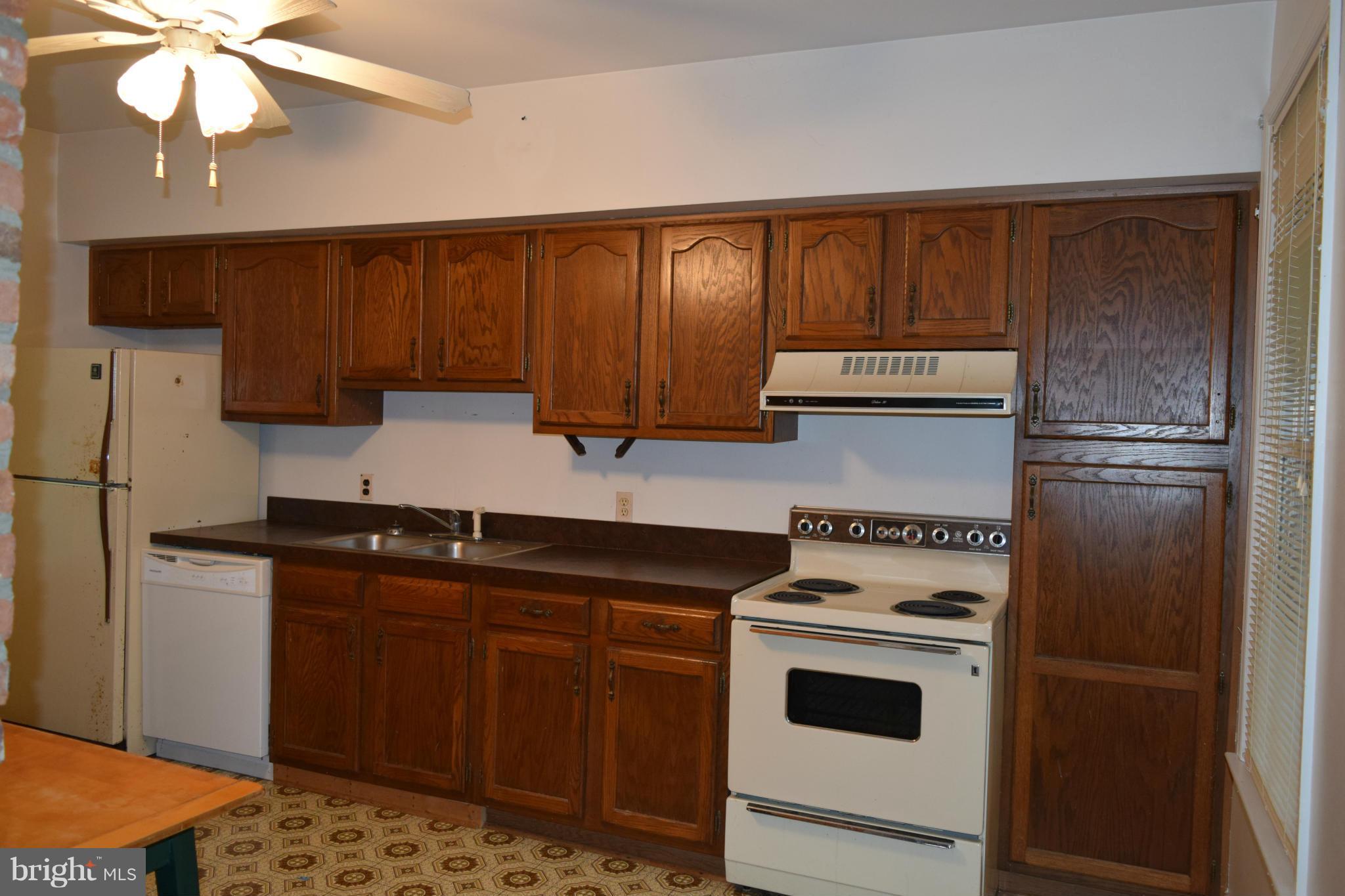 110 Persistence Lane Castleton, VA 22716 - Photo 12 of 24 a kitchen with stainless steel appliances granite countertop a stove a sink and a refrigerator