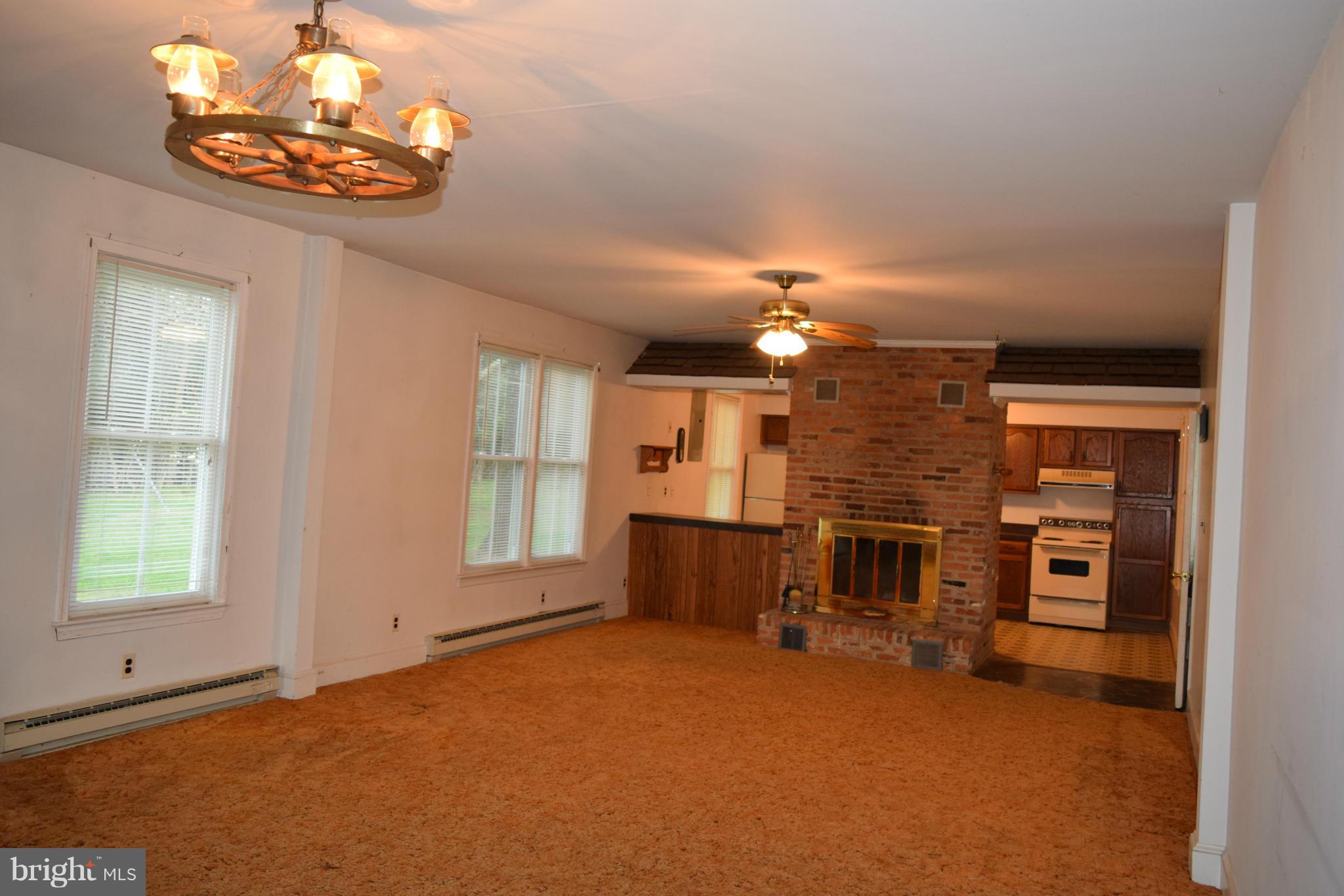 110 Persistence Lane Castleton, VA 22716 - Photo 13 of 24 an empty room with chandelier fan and windows