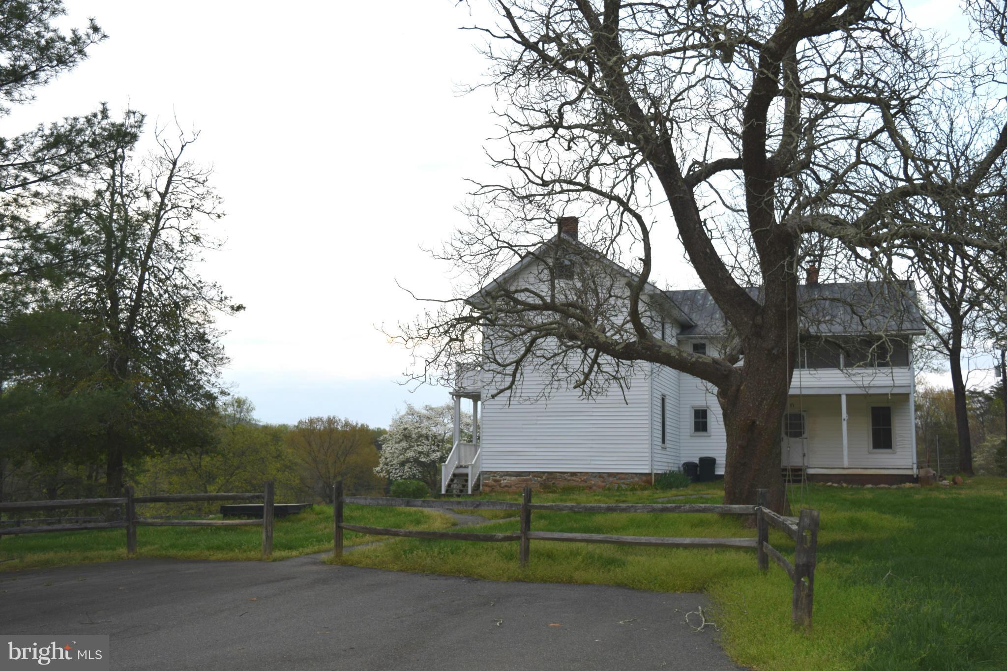 110 Persistence Lane Castleton, VA 22716 - Photo 6 of 24 a view of a white house in a big yard with large trees