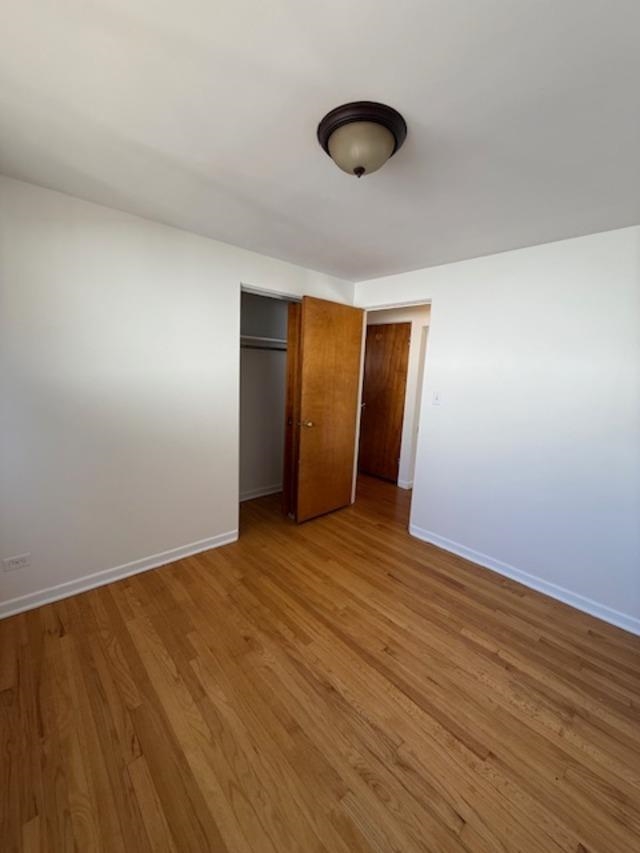 939 South Grace Street Lombard, IL 60148 - Photo 14 of 26 a view of an empty room with wooden floor and a window