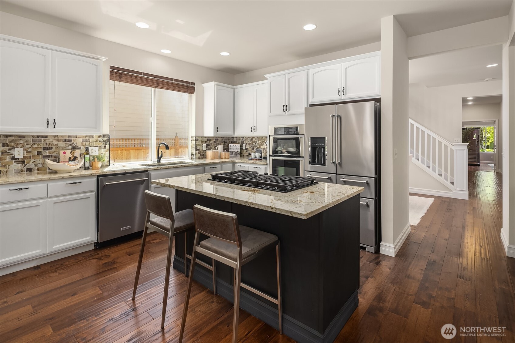 16148 Parkside Way Southeast Renton, WA 98058 - Photo 14 of 40 a kitchen with a sink a stove a refrigerator and wooden floor