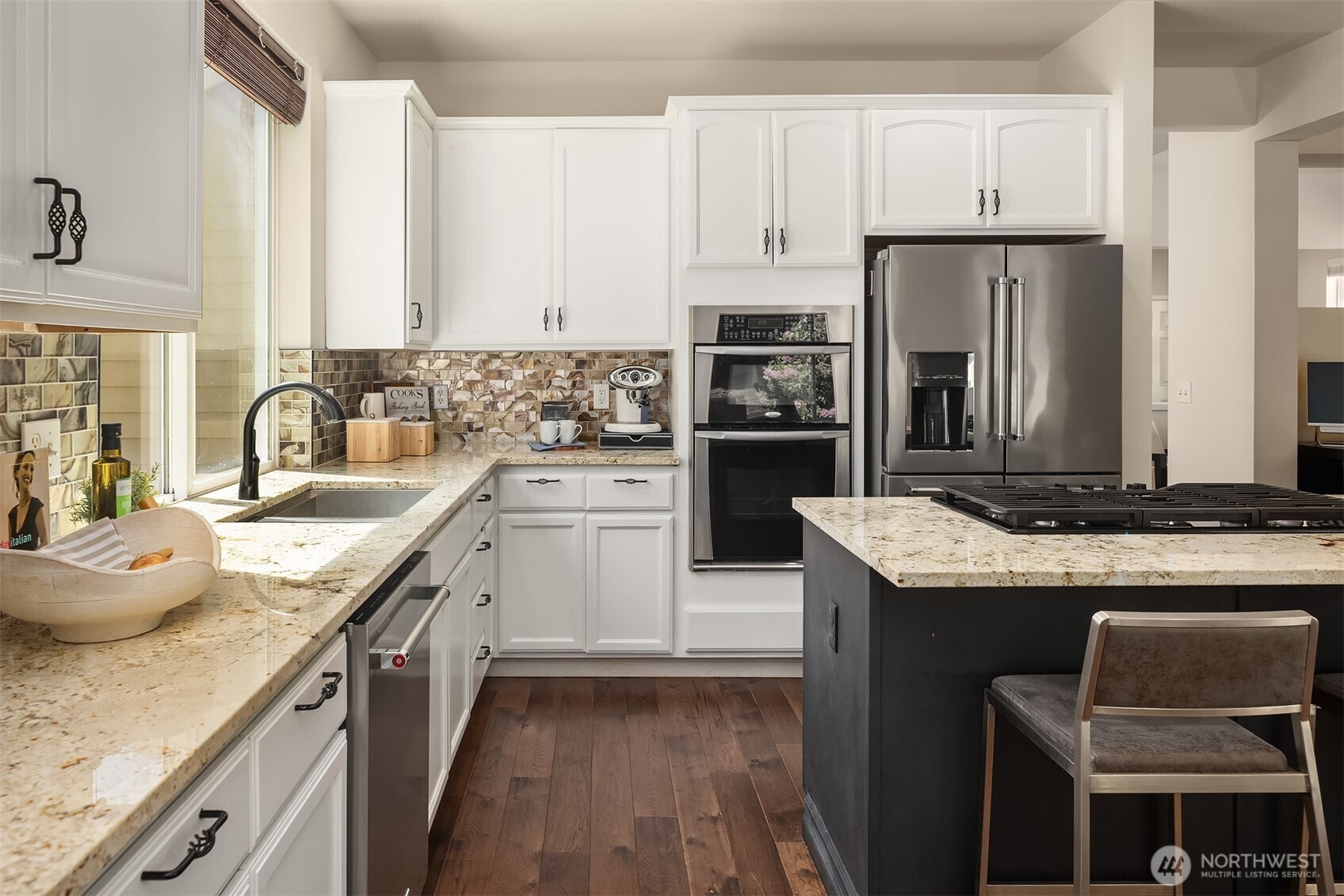 16148 Parkside Way Southeast Renton, WA 98058 - Photo 15 of 40 a kitchen with granite countertop kitchen island stainless steel appliances a sink stove refrigerator and cabinets
