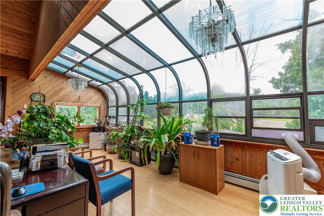 2485 Hieter Road Quakertown, PA 18951 - Photo 39 of 97 A conservatory with hardwood flooring and glass ceiling provides a serene connection to nature.