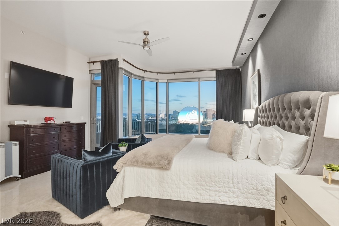 360 East Desert Inn Road, Unit 1701 Las Vegas, NV 89109 - Photo 16 of 33 Experience unparalleled city views from this well-appointed primary bedroom with recessed lighting and sophisticated finishes.
