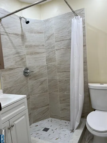 a bathroom with a toilet and a shower