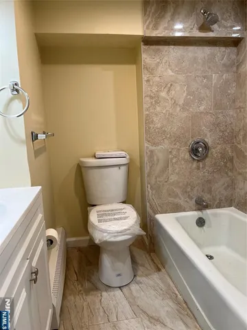 a bathroom with a toilet and a bathtub