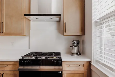 a kitchen with a stove and a refrigerator