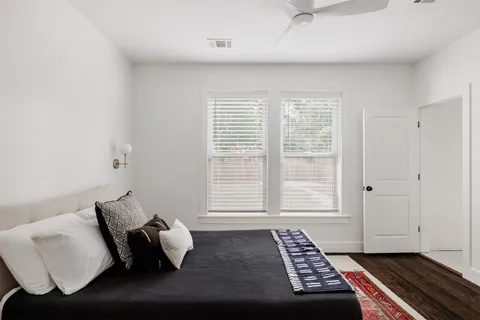a bedroom with a bed and wooden floor