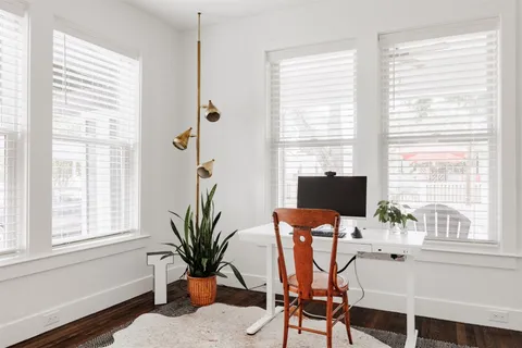 a dining room with furniture and window