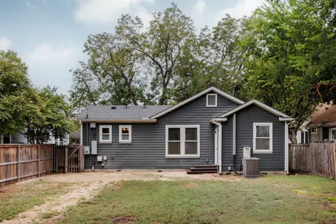 a front view of a house with yard and trees