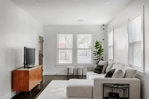 a living room with furniture and a flat screen tv