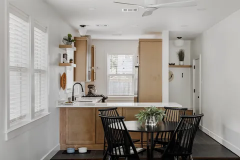 a view of a a dining room with furniture window and wooden floor
