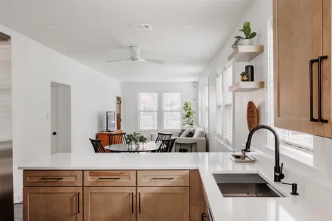 a kitchen with a white cabinets and chandelier