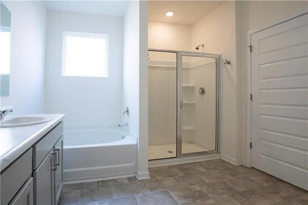 a bathroom with a bathtub shower sink vanity and a toilet